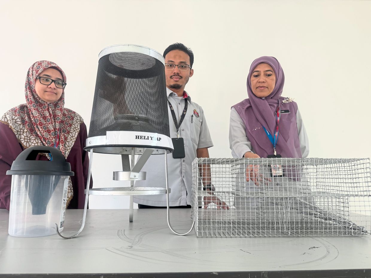 (From left) DBKL public health department senior deputy director Dr Shariza Natasha Hariri, Dr Muhammad Firdaus and Dr Umi showing devices to catch (from left) mosquitoes, flies and rats. — Photos: MUHAMAD SHAHRIL ROSLI/The Star